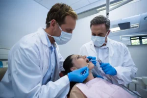 dentists examining a female patient with tools 2023 11 27 05 10 40 utc